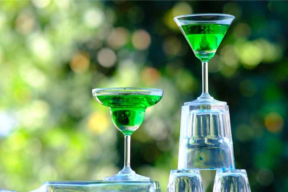 green martinis stacked on glasses
