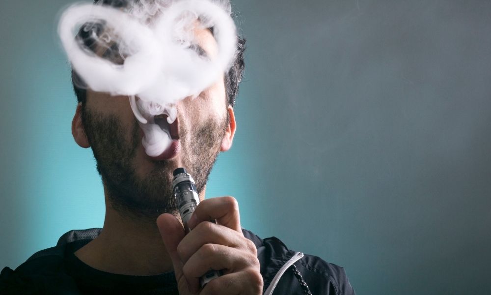 man blowing clouds of vapor