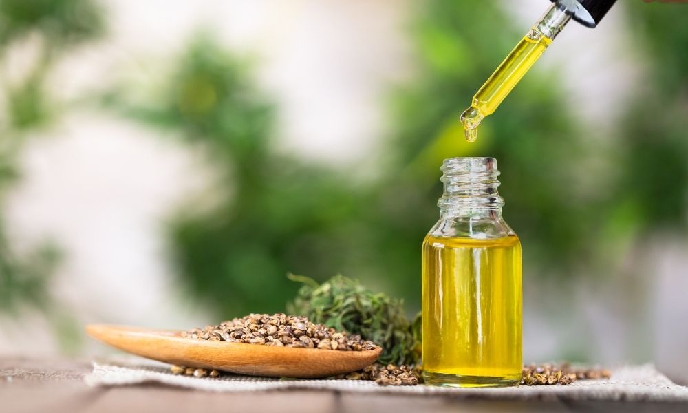 hemp seeds and oil on a wooden bench