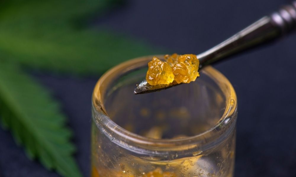 golden dab of cbd concentrate on spoon