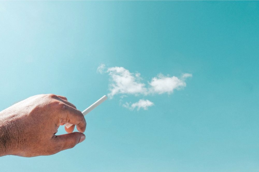 man smoking cigarette with cloud