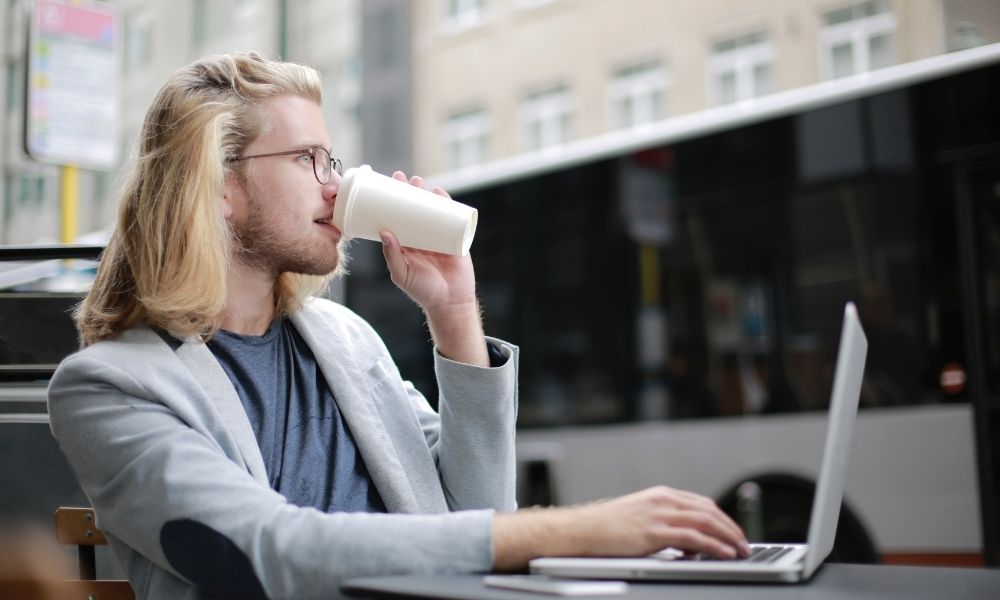 human sipping coffee while working
