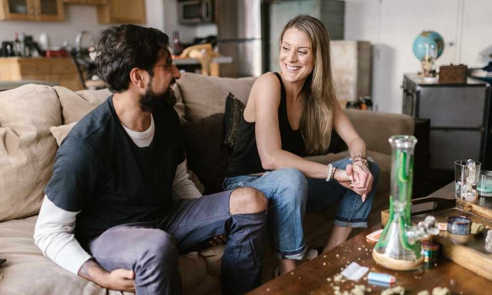 couple looking at each other over bong