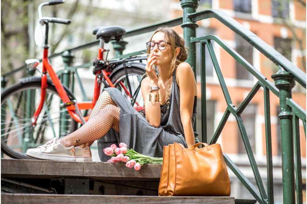woman smoking next to her bike