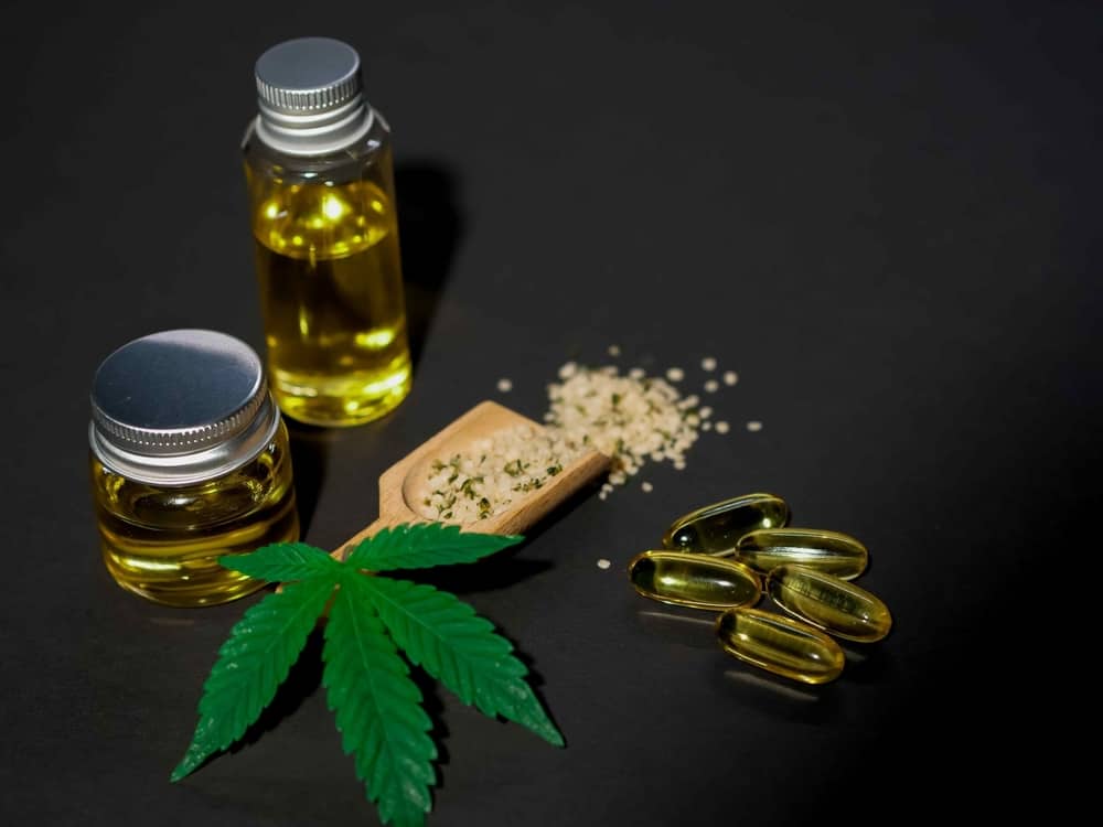 cbd oil with capsules and leaf