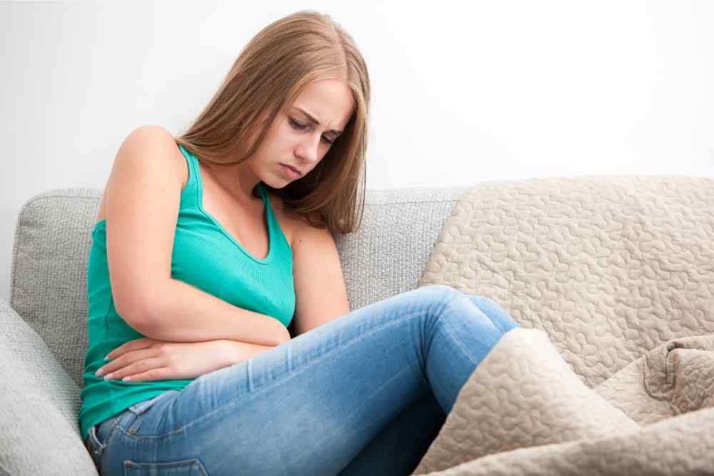 woman in discomfort from abdominal pain