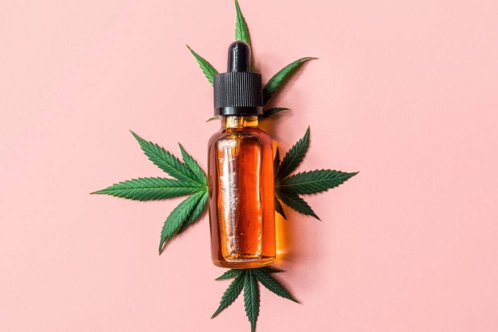 CBD oil tincture with pink background
