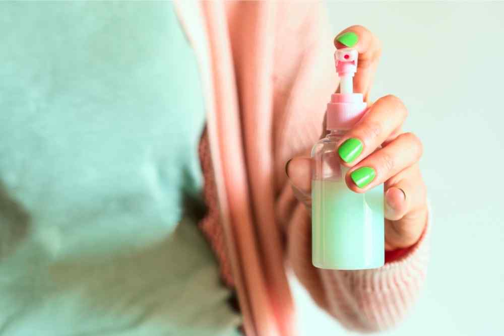woman with green nails pump lotion