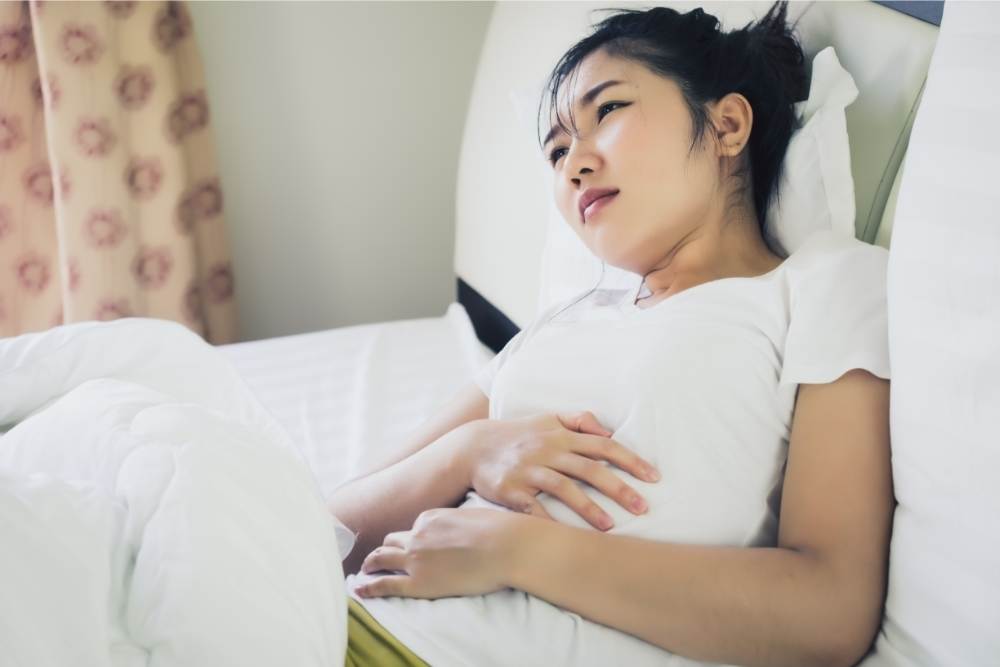 woman suffering from nausea stomach discomfort