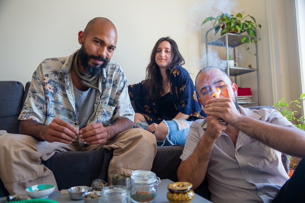 three stoners enjoying 420 at home